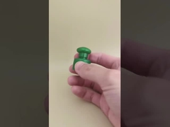 Bouchon lisse en plastique vert avec bouton pour flacons cosmétiques