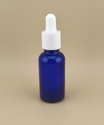 Flacon compte-gouttes rond lisse bleu foncé transparent au design délicat pour les soins de la peau