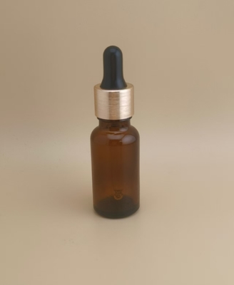 Flacon compte-gouttes rond, lisse, transparent et marron, de petite taille, au design délicat, pour les soins de la peau