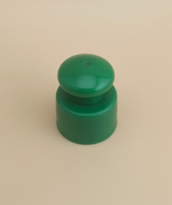Bouchon lisse en plastique vert avec bouton pour flacons cosmétiques